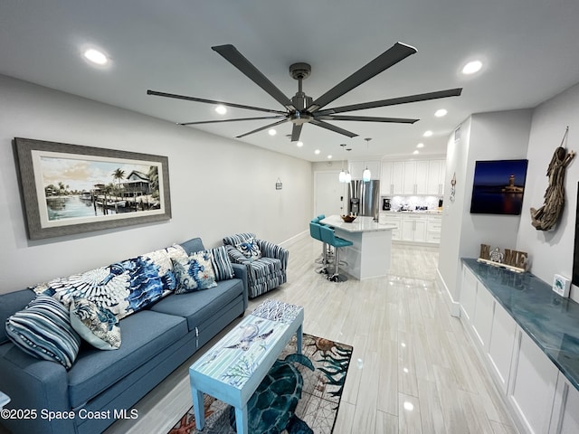 living room with ceiling fan and light wood-type flooring