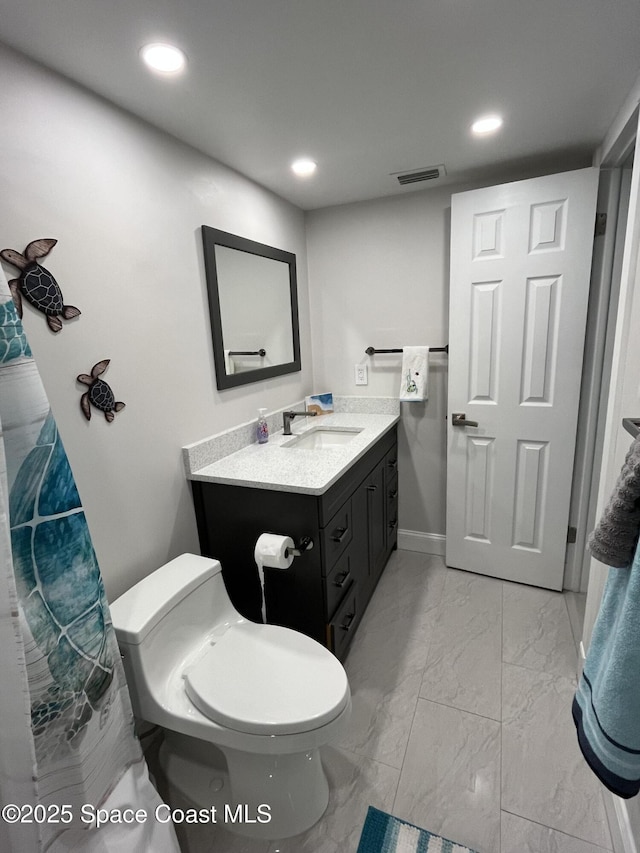 bathroom with vanity and toilet