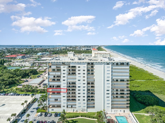 drone / aerial view featuring a view of the beach and a water view