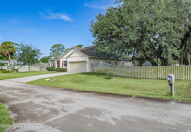 view of front of property with a garage and a front yard