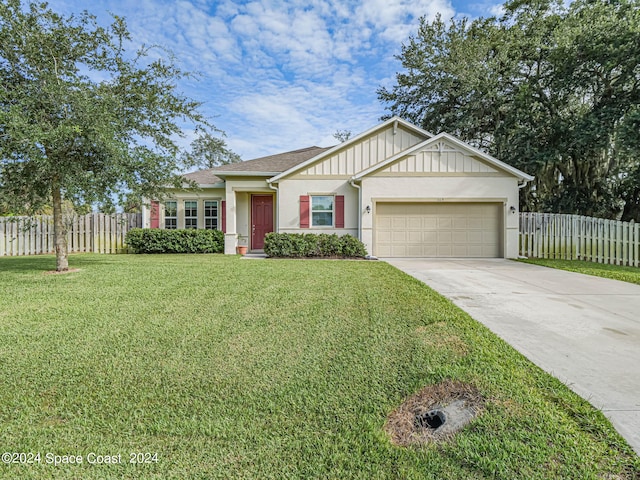 view of front of home featuring a garage and a front yard