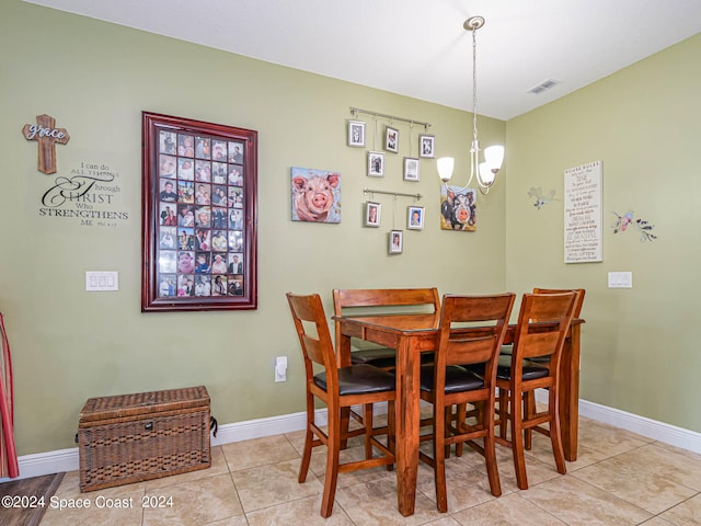 dining room featuring light tile patterned floors and a chandelier