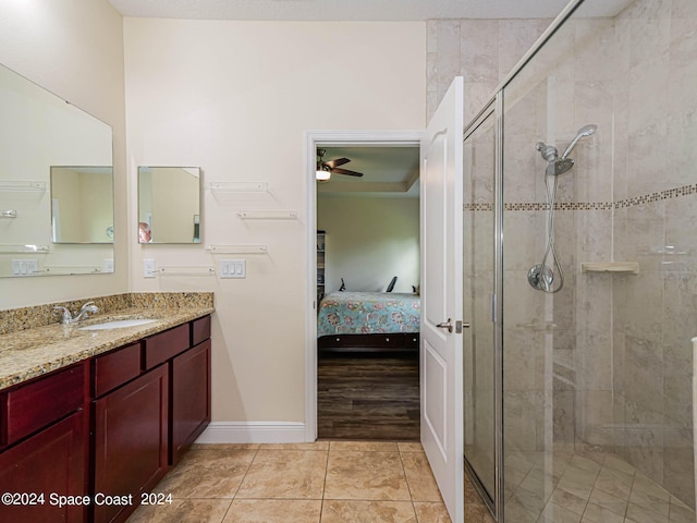 bathroom featuring vanity, ceiling fan, tile patterned floors, and a shower with shower door