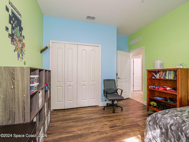 bedroom featuring a closet and dark hardwood / wood-style flooring