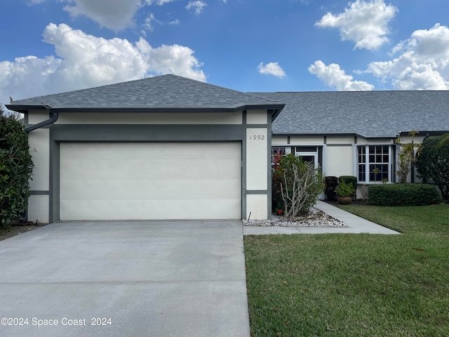 ranch-style house featuring a front yard and a garage