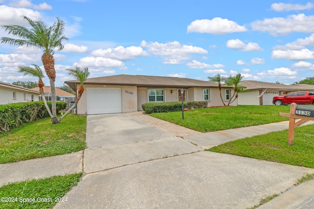 single story home with a garage and a front yard