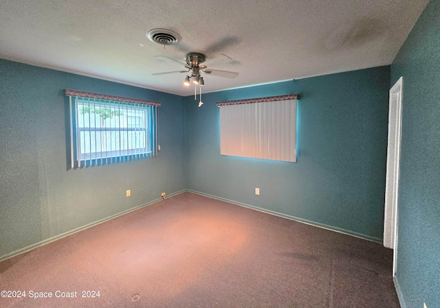 carpeted empty room with a textured ceiling and ceiling fan