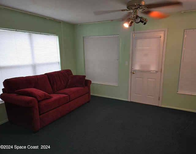 carpeted living room featuring ceiling fan