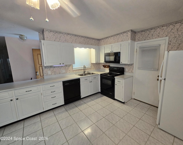 kitchen with a sink, white cabinetry, light countertops, black appliances, and tasteful backsplash