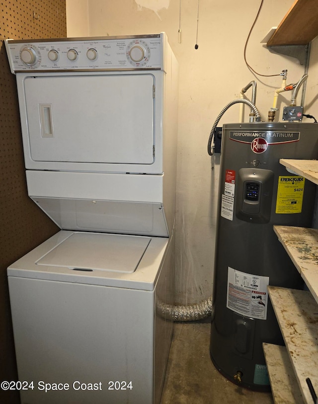 clothes washing area featuring electric water heater and stacked washer / dryer