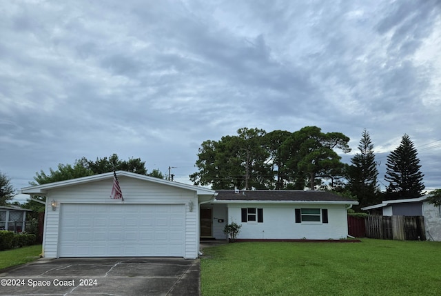 ranch-style home featuring a garage and a front lawn