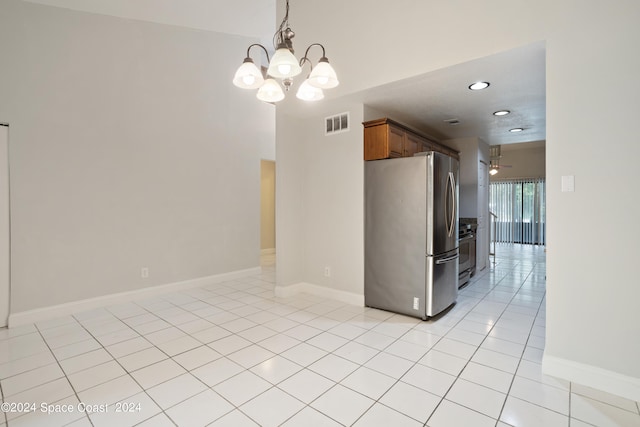 kitchen featuring ceiling fan with notable chandelier, pendant lighting, light tile patterned floors, and stainless steel appliances