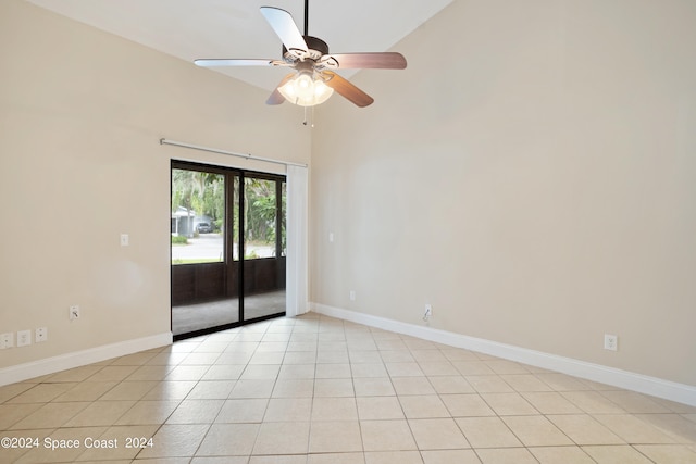 spare room featuring high vaulted ceiling, light tile patterned flooring, and ceiling fan