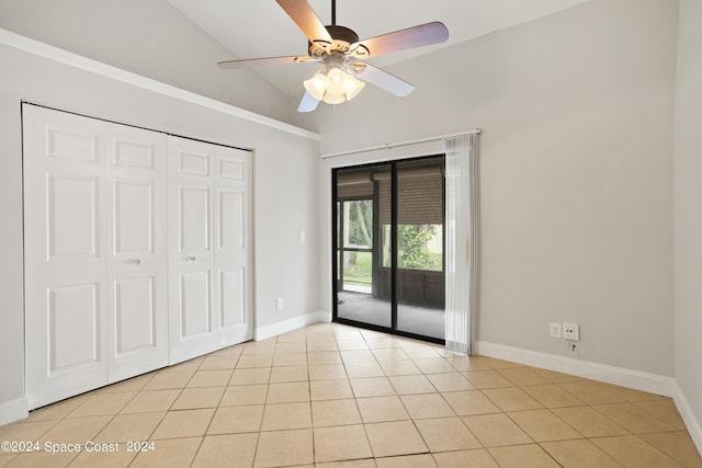 unfurnished bedroom with vaulted ceiling, baseboards, light tile patterned flooring, access to exterior, and ceiling fan