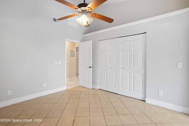 unfurnished bedroom with a closet, ceiling fan, and light tile patterned flooring