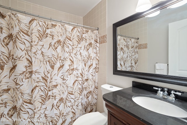 bathroom with vanity, toilet, and a shower with curtain