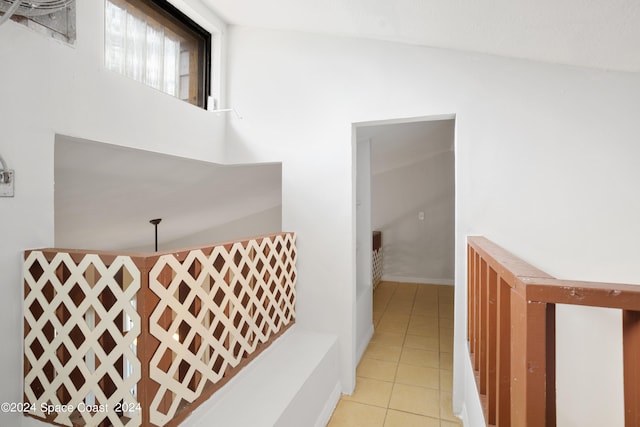 hall with light tile patterned floors