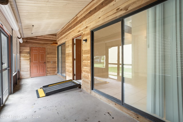 unfurnished sunroom featuring vaulted ceiling