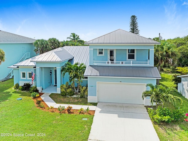 view of front of property with a garage and a front lawn