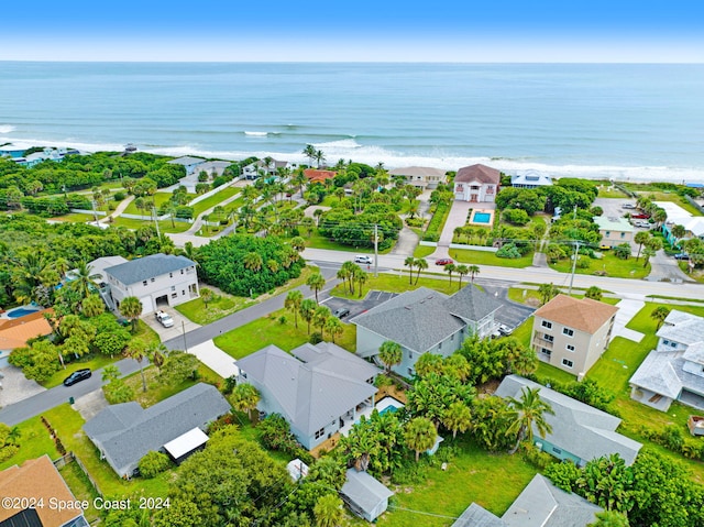 bird's eye view featuring a water view and a beach view