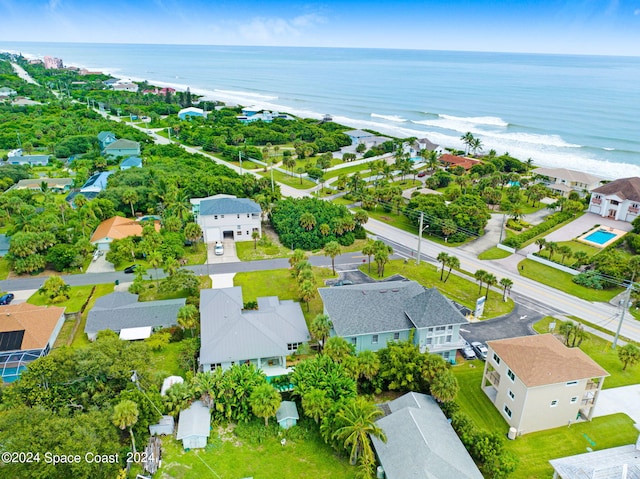 drone / aerial view with a beach view and a water view