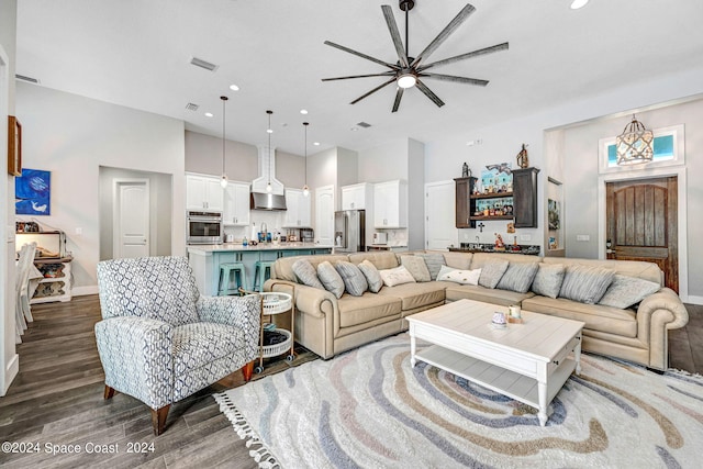 living room with ceiling fan and hardwood / wood-style floors