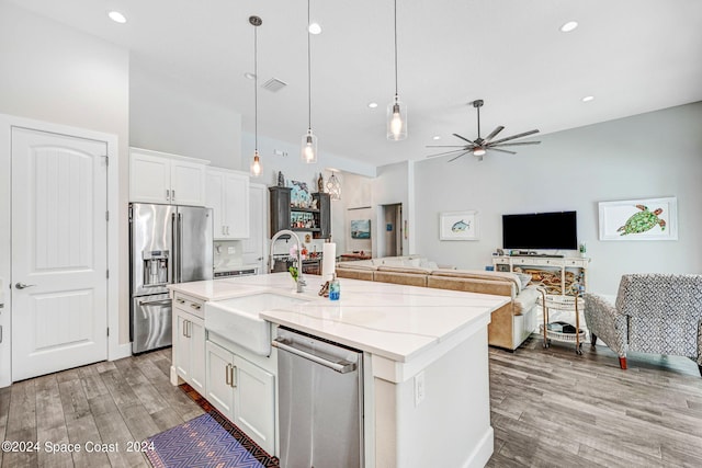 kitchen featuring white cabinetry, ceiling fan, appliances with stainless steel finishes, and a kitchen island with sink