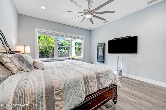 bedroom featuring hardwood / wood-style floors and ceiling fan