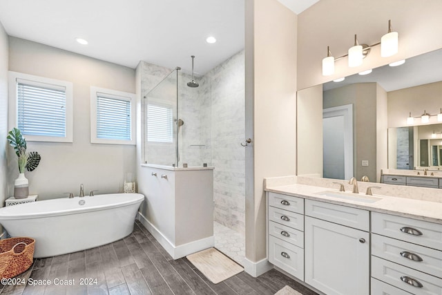 bathroom with vanity, separate shower and tub, and hardwood / wood-style floors