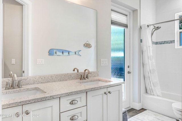 full bathroom with shower / bath combo, toilet, vanity, and hardwood / wood-style floors