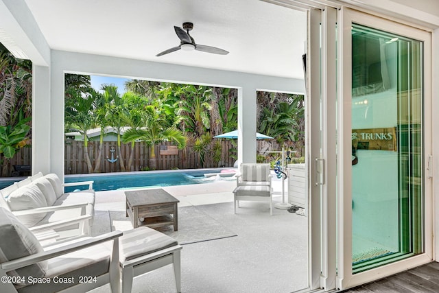 view of patio featuring ceiling fan and a fenced in pool