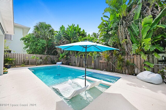 view of swimming pool with an in ground hot tub and a patio area