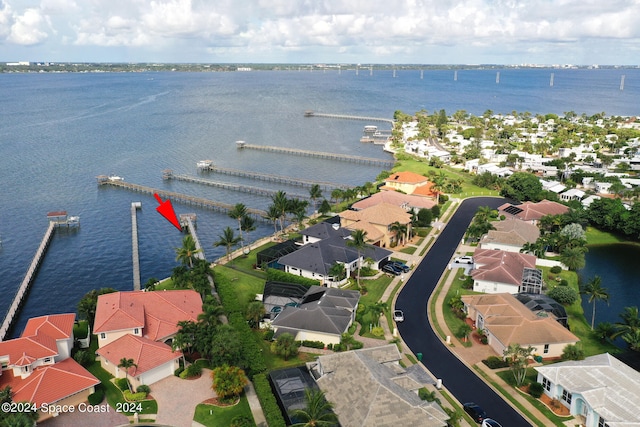 birds eye view of property with a water view