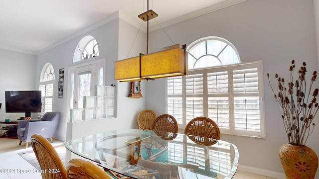 dining space with a wealth of natural light and crown molding