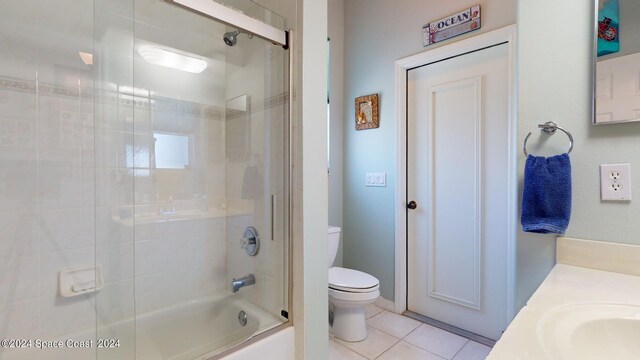 full bathroom with tile patterned flooring, toilet, enclosed tub / shower combo, and vanity