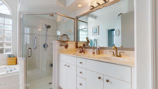 bathroom featuring plenty of natural light, vanity, and shower with separate bathtub