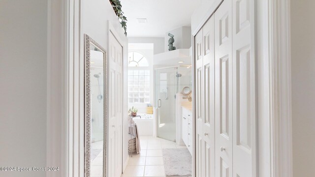 hall featuring light tile patterned floors