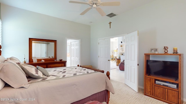 carpeted bedroom featuring ceiling fan and a closet