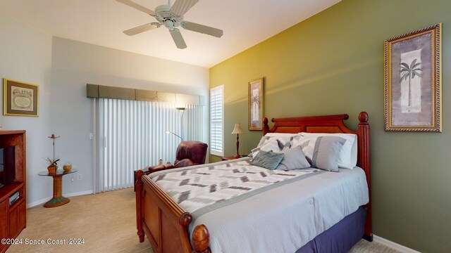 carpeted bedroom featuring ceiling fan and vaulted ceiling