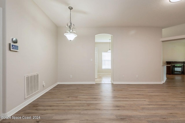 empty room with hardwood / wood-style floors