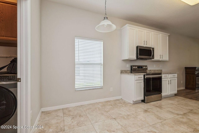 kitchen featuring white cabinets, decorative light fixtures, light stone counters, stainless steel appliances, and washer / clothes dryer