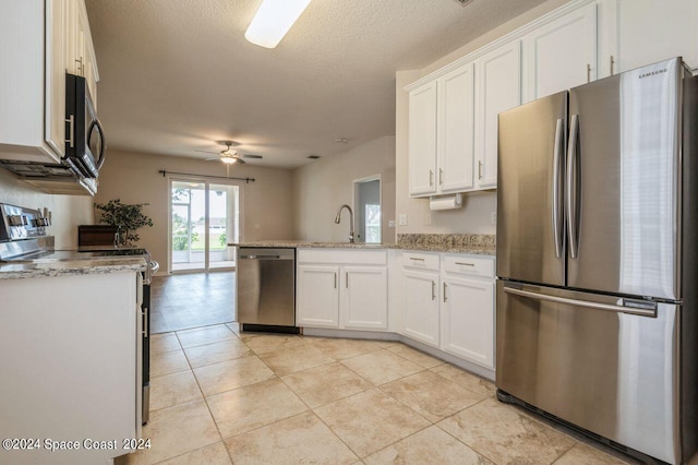 kitchen with appliances with stainless steel finishes, a textured ceiling, white cabinetry, and ceiling fan