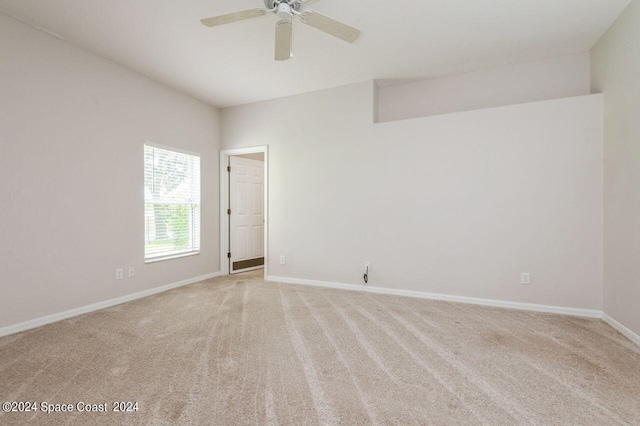 unfurnished room featuring ceiling fan and light colored carpet