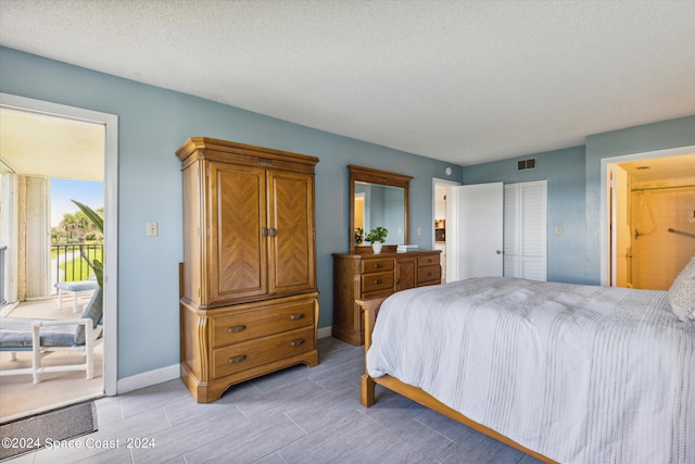 bedroom featuring a textured ceiling and a closet