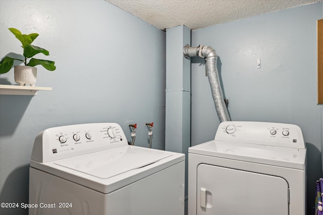 washroom featuring separate washer and dryer and a textured ceiling