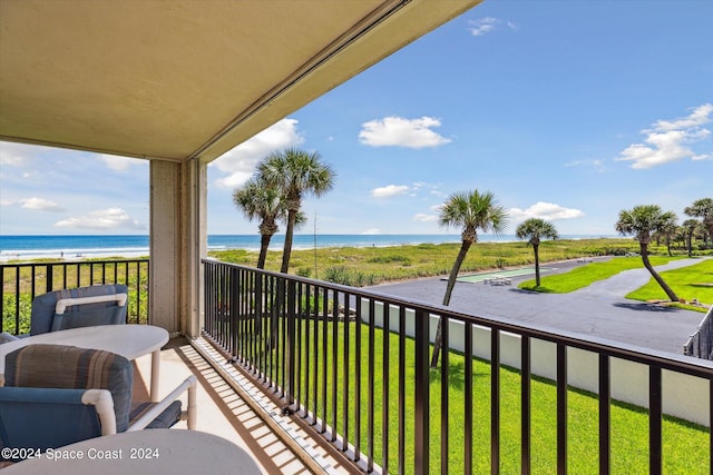 balcony with a beach view and a water view