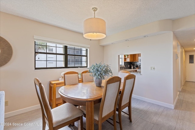 dining space with a textured ceiling