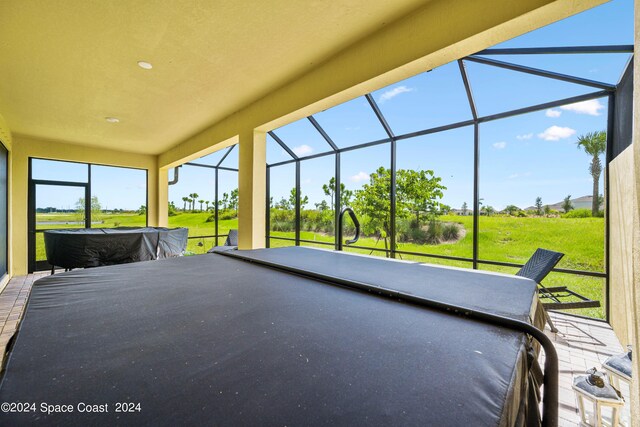 view of patio featuring glass enclosure