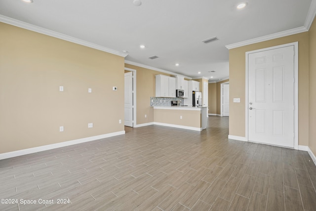 unfurnished living room featuring light wood-type flooring, baseboards, visible vents, and ornamental molding