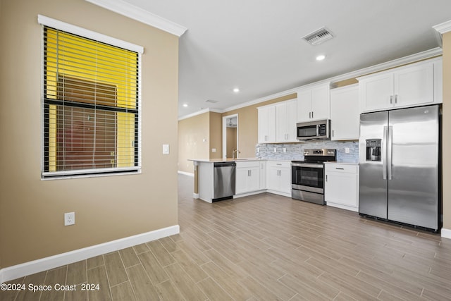 kitchen with visible vents, appliances with stainless steel finishes, decorative backsplash, and ornamental molding